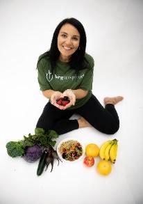 A person sitting on the floor with fruits and vegetables

Description automatically generated